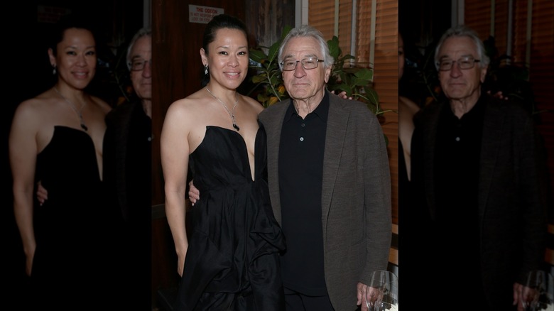 Robert De Niro holding Tiffany Chen by the waist
