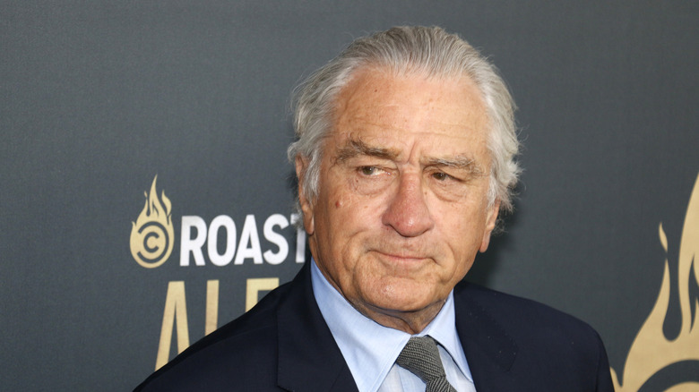 Robert De Niro with lips pursed and looking serious