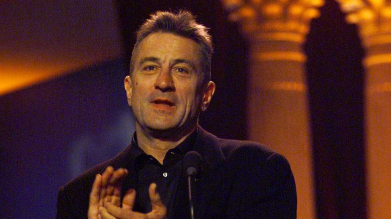 Robert De Niro applauding with short cropped hair