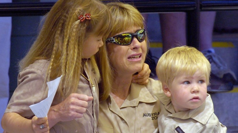 A crying Terri Irwin holding Bindi and Robert as children