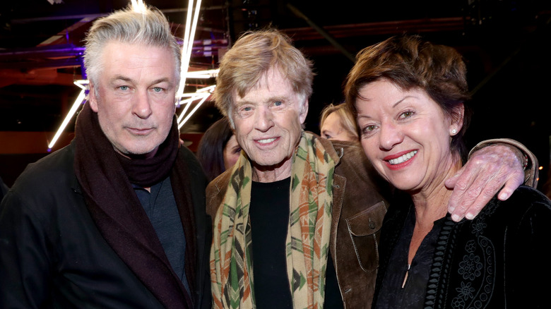 Alec Baldwin, Robert Redford, and Sibylle Szaggars smiling together
