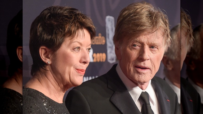 Sibylle Szaggars smiling while Robert Redford looks at her