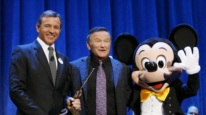 Robin Williams, standing next to Bob Iger, being recognized for his contributions to Disney in 2009
