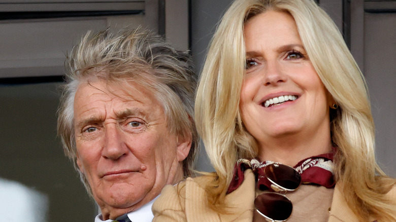 Rod Stewart looking serious and Penny Lancaster smiling