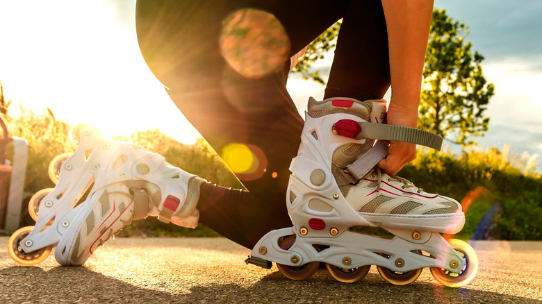 Woman tightening her roller blades