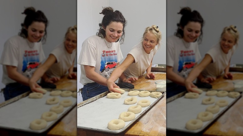 Rose Kennedy Schlossberg and Rory McAuliffe smile as they bake bagels