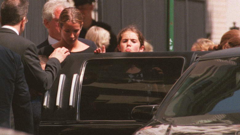 Rose Kennedy Schlossberg sticking her tongue out at paparazzi as she gets into black limo