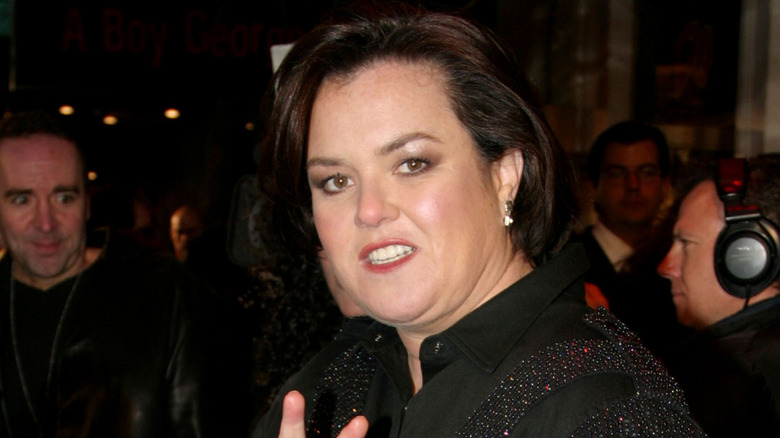 Closeup of Rosie O'Donnell turning to her left and smiling toward the camera in crowd