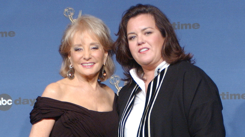 Barbara Walters and Rosie O'Donnell smiling together in step-and-repeat