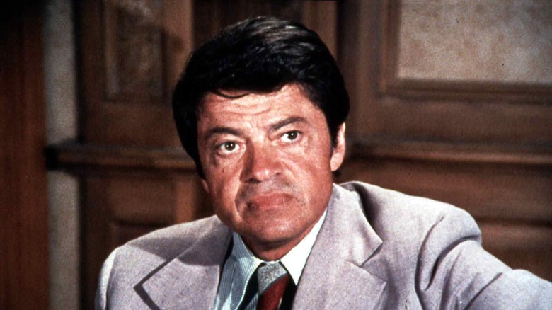 Ross Martin in a light-colored suit in a color still from a television scene