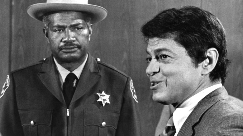 Ross Martin appears beside a uniformed officer