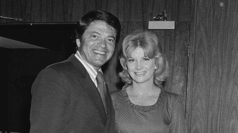 Ross Martin stands beside his wife, Olavee, in a black-and-white portrait