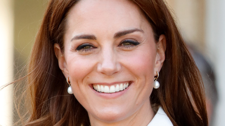 Kate Middleton smiles for a photo. 