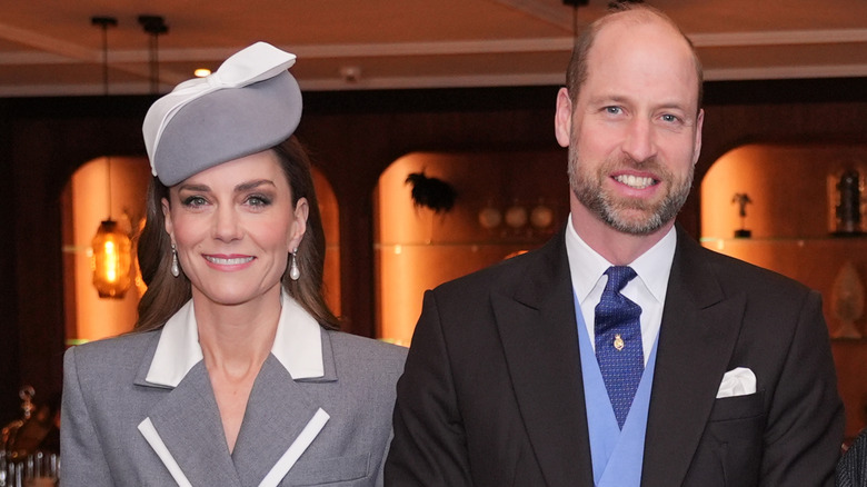 Princess Catherine and Prince William smiling while posing next to each other