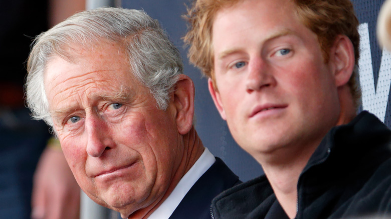 Prince Charles with son Harry at an event. 