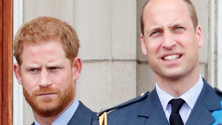 Prince Harry and Prince William standing on a balcony