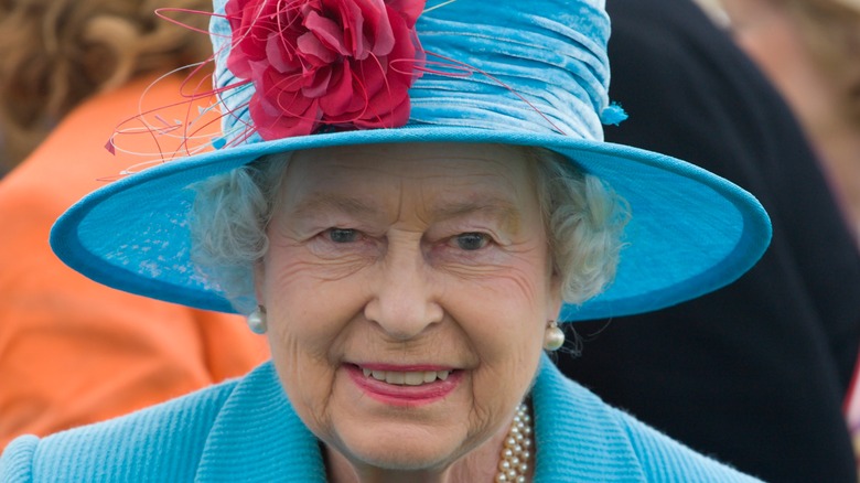 Queen Elizabeth light blue hat red flower