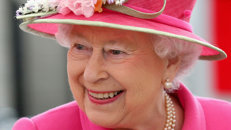 Queen Elizabeth wearing pink hat