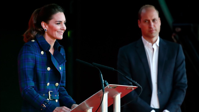 Kate Middleton giving a speech while Prince William watches