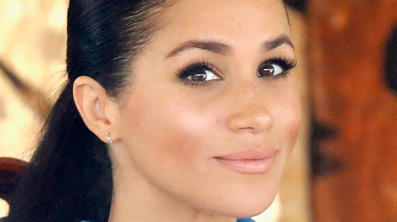 Meghan Markle looks knowingly at the camera