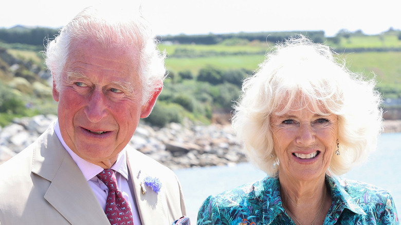 Prince Charles and Camilla standing on a beach together