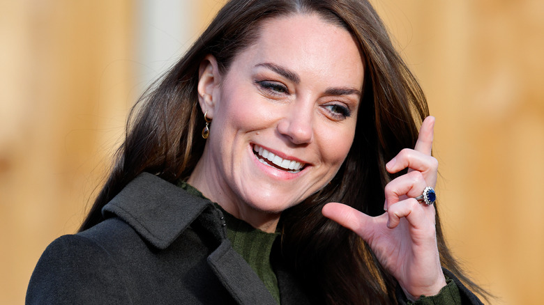 Kate Middleton fixing hair wearing ring