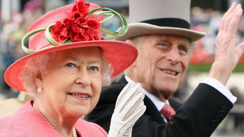 Queen Elizabeth and Prince Philip waving