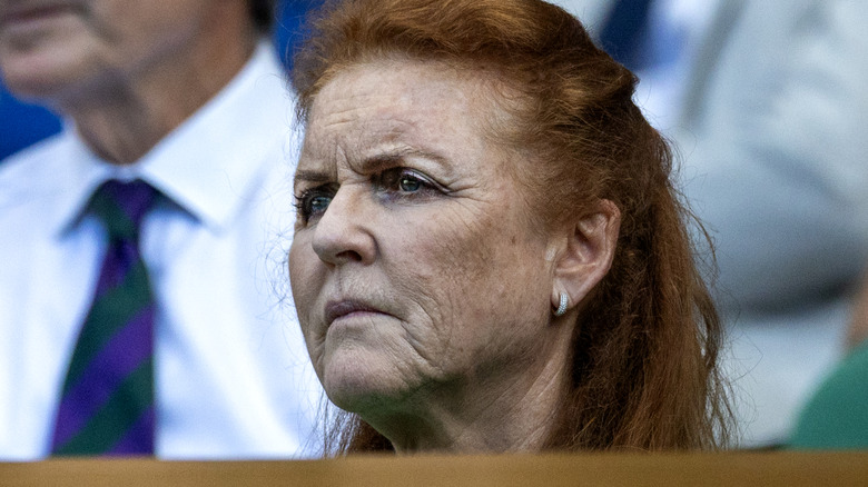 Sarah Ferguson with a deep frown watching a match