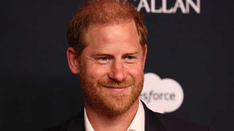 Prince Harry smiling while posing at an event