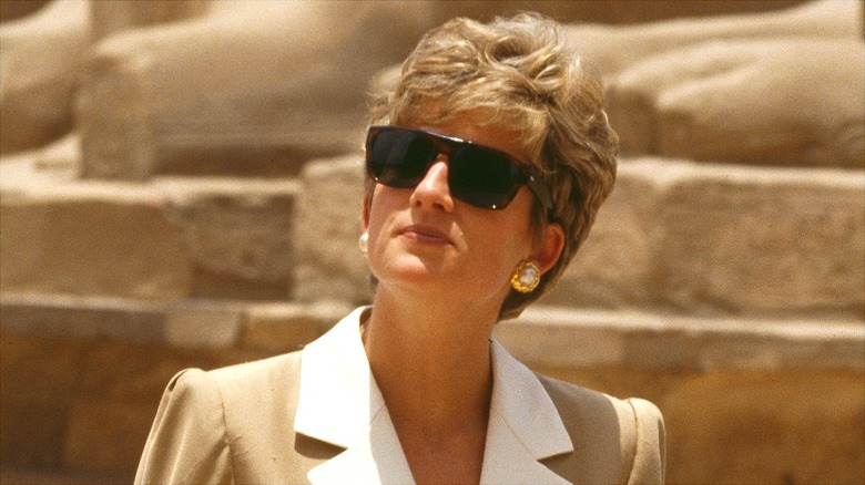 Princess Diana in Egypt in a beige and white dress with gold earrings