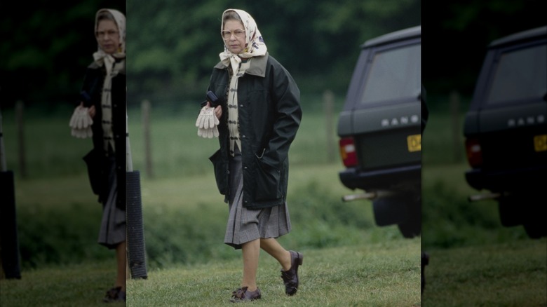 Queen Elizabeth II at the Windsor Horse Show in a headscarf and outerwear