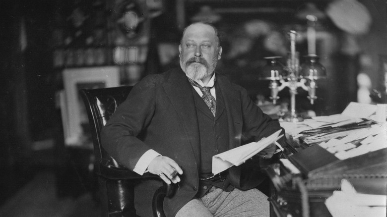 King Edward VII sitting at a desk