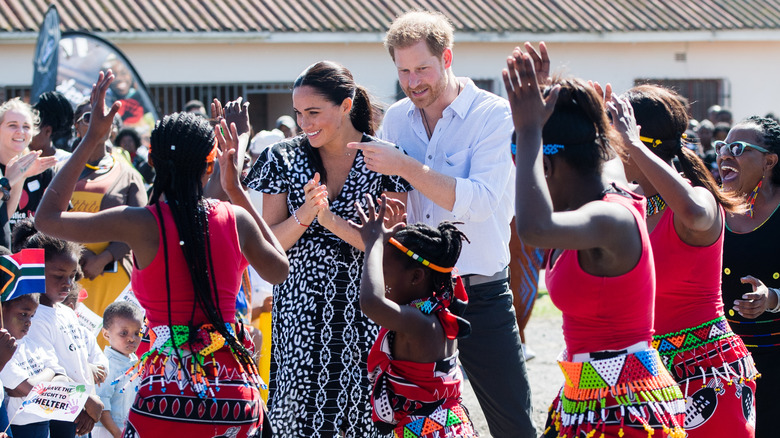 Prince Harry and Meghan Markle among dancing women