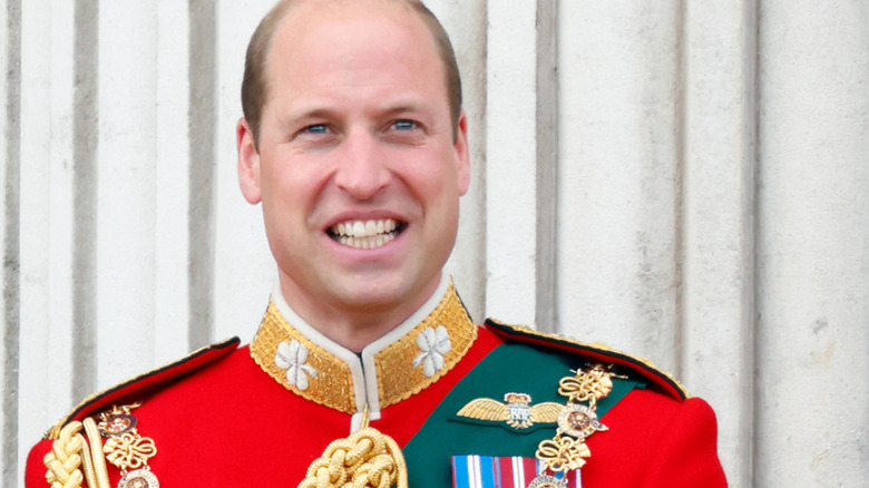 Prince William smiling on the Buckingham Palace balcony