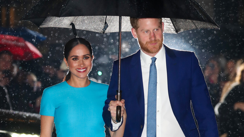 Harry and Meghan under an umbrella