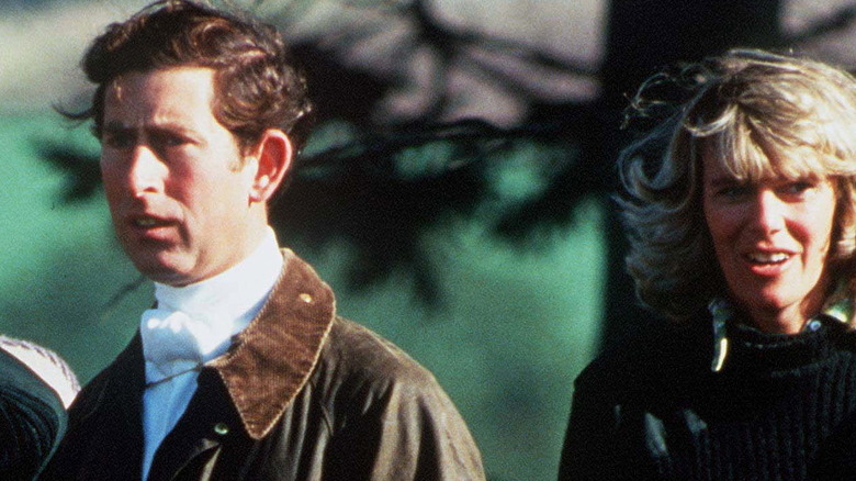 A young King Charles and Queen Camilla together at outdoor event