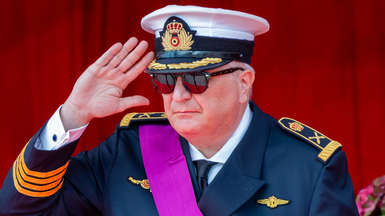 Prince Laurent of Belgium saluting in military uniform and sunglasses