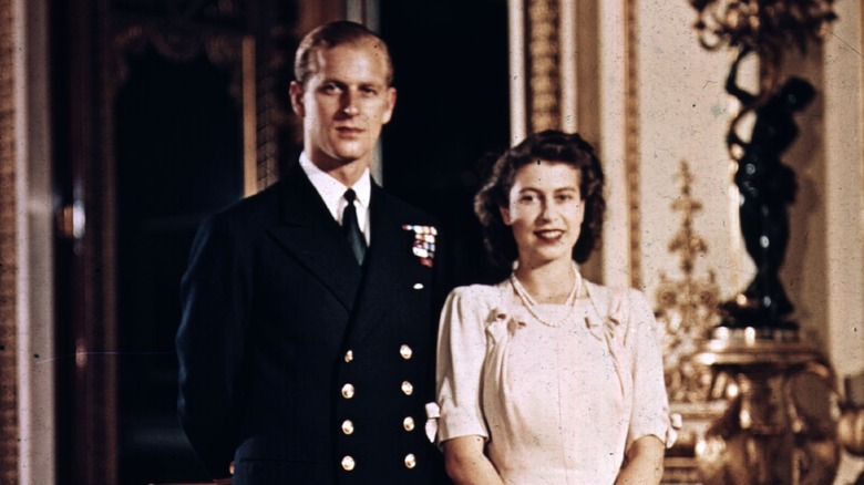 Queen Elizabeth standing next to Prince Philip