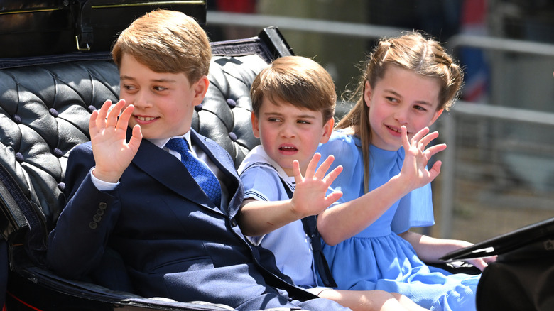 Prince George, Prince Louis, and Princess Charlotte riding in a carriage
