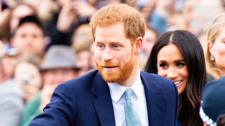 Harry and Meghan walking in crowd