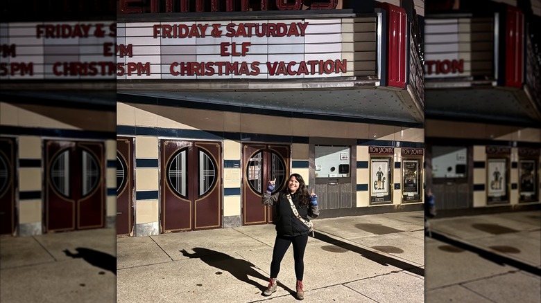 Ellen Latzen posing beneath a movie theater sign