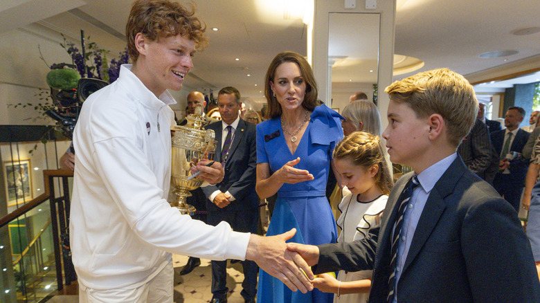 Pince George shaking hands