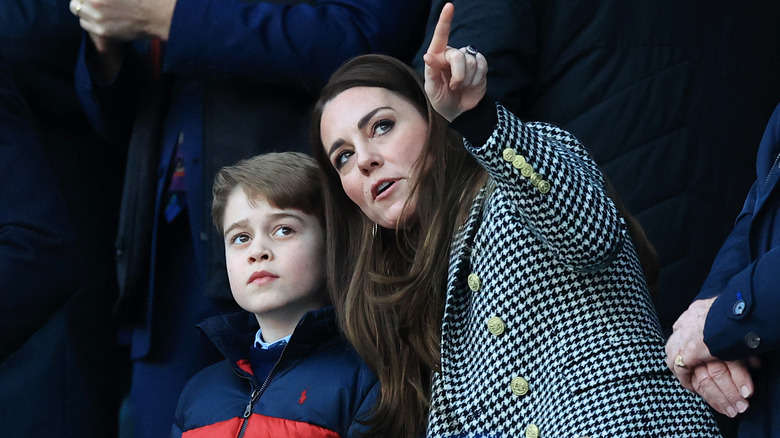 Prince George leaning into Princess Catherine
