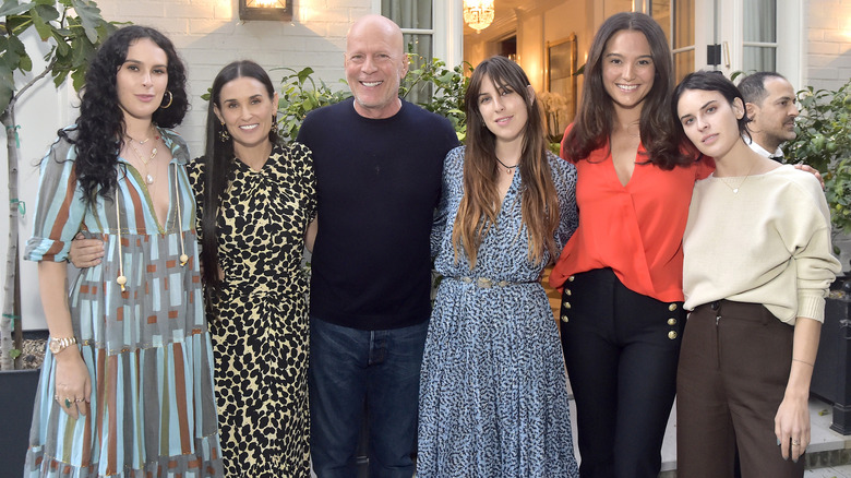 Bruce Willis posing with his wife, ex-wife, and three daughters