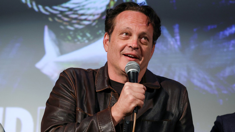 Vince Vaughn talking into a microphone.