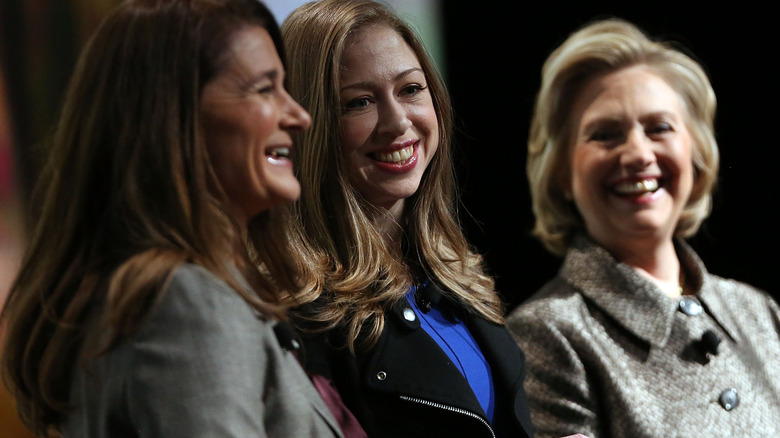 Melina Gates, Chelsea Clinton, and Hillary Clinton laughing