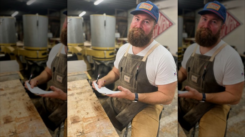 Ben Napier holding a piece of paper while wearing his work clothes