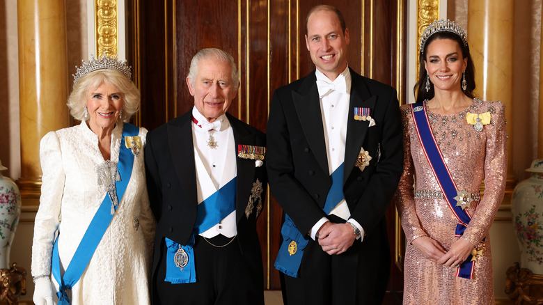 Queen Camilla, King Charles III, Prince William, and Princess Kate smiling