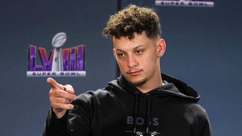 Patrick Mahomes pointing in a black hoodie