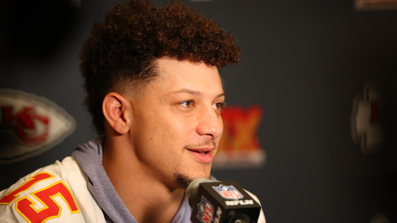 Patrick Mahomes speaking into a microphone